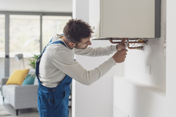 Professional plumber checking a boiler