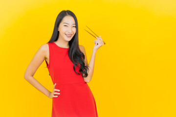 Poster - Portrait beautiful young asian woman with chopstick