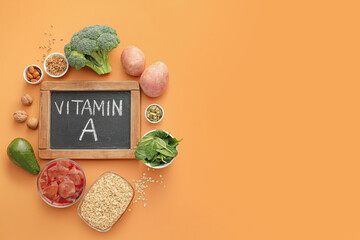 Healthy products rich in vitamin A on color background