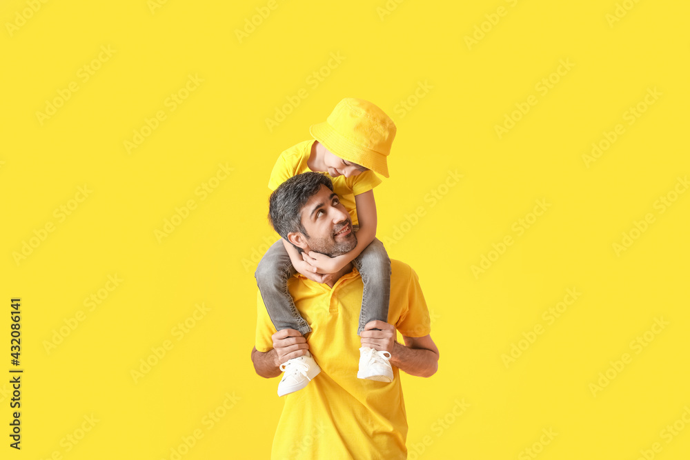 Happy father and his little son on color