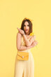 © Pixel-Shot - Stylish young woman on yellow background
