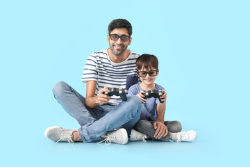 Sticker - Father and little son playing video games on color background