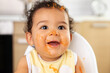 © Lisa Tichané - Close up portrait of cute baby in high chair with messy face