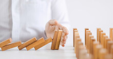 Businessman Use Hand To Protect Wooden Blocks From Domino Block Falling