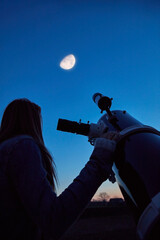 Wall Mural - woman looking at night sky with amateur astronomical telescope.