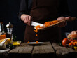 © Anton - The chef prepares slicing dried apricots for cooking. Culinary recipes