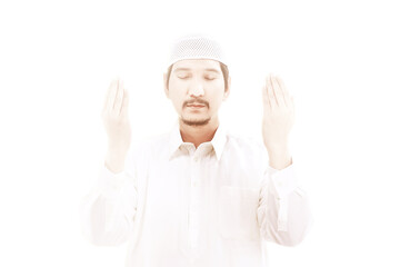 Wall Mural - Asian Muslim man sitting while raised hands and praying