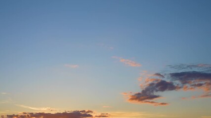 Wall Mural - video time lapse of beautiful peaceful cloudy sunset clear blue heaven. white and orange sunny soft 