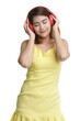 Isolated portrait close up shot of Asian happy female teenager wear large red headphones stand and close eyes listening to music and dancing.