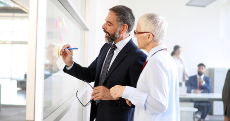 Portrait of happy business people discussing together in office