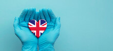 Doctors Hands Wearing Surgical Gloves Holding United Kingdom Flag Heart