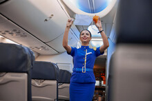 Stewardess Is Showing Safety Rules Before Fly At Evening Plane Salon