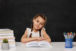 © producer - little child girl reading a book in the classroom
