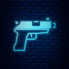 Canvas Print - Glowing neon Pistol or gun icon isolated on brick wall background. Police or military handgun. Small firearm. Vector