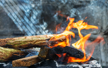 Blazing fire in close-up, bonfire on stone background