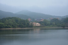 Foggy Lakes, Mountains And Buildings.