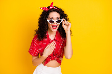 Poster - Photo of cute impressed brunette hair lady hand chest wear red top band isolated on yellow color background