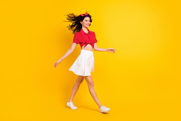 Canvas Print - Full size profile photo of cute optimistic brunette hair lady go wear red top skirt sneakers isolated on yellow color background