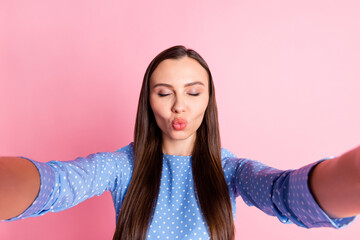 Sticker - Photo portrait of beautiful girl sending air kiss taking selfie wearing blue dotted dress isolated on pastel pink color background