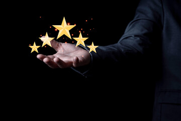 Businessman holding virtual five stars for customer feedback rating and evaluation concept.