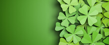 Cloverleaf Background Isolated On A Green Background To The Left. All Clovers Are Four-leafed. Spring Or Luck Concept. Web Banner Format.