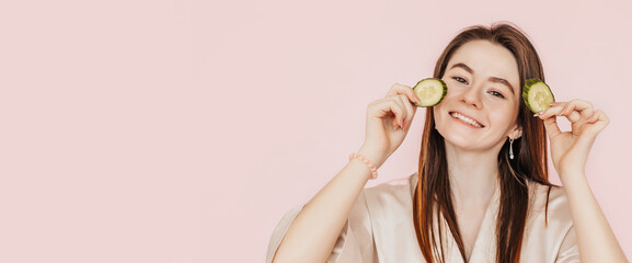 Wall Mural - girl make homemade face beauty masks. cucumbers for the freshness of the skin around the eyes. woman