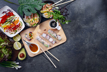 Wall Mural - fresh springrolls with vegetables and shrimps. a healthy dish of rice paper and fresh organic vegetables