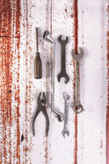 Sticker - Top view of old weathered rusty tools on a grunge background