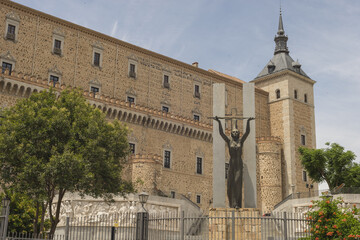 Poster - Female statue in the city of Toledo Spain on the background of a building