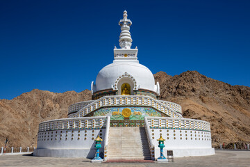 White buddhist stupa or pagoda in tibetan monastery near village Leh in ladakh, noth India