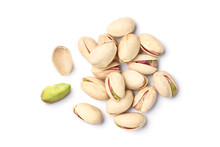 Flat lay of pistachio nuts on a white background.