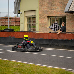 Wall Mural - A panning shot of a racing kart as it circuits a track.