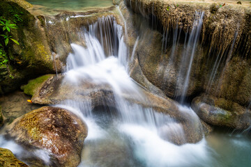 Waterfall and blue emerald water color in Erawan national park. Erawan Waterfall, Beautiful nature rock waterfall steps in tropical rainforest at Kanchanaburi province, Thailand