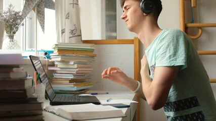 Poster - The freelancer at the table looks at the laptop. Makes movements with the back, increasing the tone of the body in sedentary work. Headphones on the head.