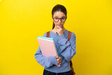 Fototapeta  - Student kid woman over isolated yellow background thinking