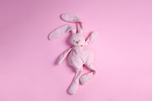 Top View Of Cute Pink Plush Rabbit Dancing On Pink Background With Copy Space