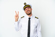 © luismolinero - Airplane Brazilian pilot isolated on white background smiling and showing victory sign