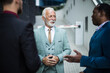 © liderina - Three business men talking. Focus is on senior man.