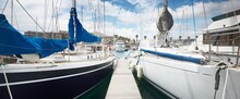 Sailboats Moored To A Pier On A Clear Day, Close-up. Yacht Marina In Cascais, Portugal. Sailing, Sport, Leisure Activity, Recreation, Vacations, Travel Destinations Theme