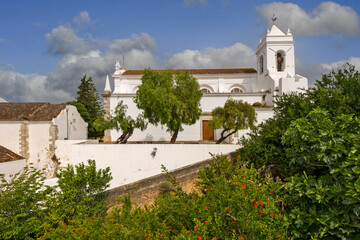 the clock tower and the church of Santa Maria do Castelo in Tavira, Algarve, Portugal