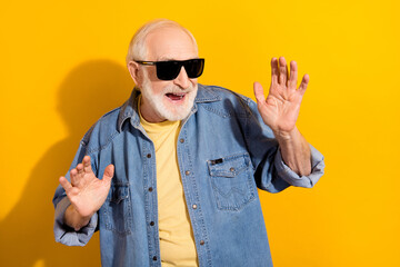 Poster - Photo of positive aged man hands palms toothy smile enjoy free time partying isolated on yellow color background