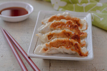 Wall Mural - Fried dumplings Gyoza on plate and soy sauce.