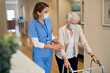 © Rido - Nurse helping senior woman walk at nursing home