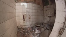 A Derelict Ruins Of A Public Toilet Washroom With Everything Broken