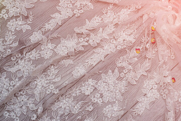 White wooden background with white spring flowers roses and lace ribbon. Happy womans day. The texture of lace on wooden background.