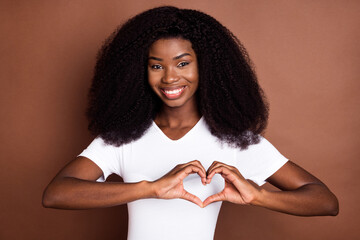 Portrait of charming positive lady hands fingers show make heart symbol isolated on brown color background