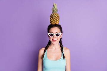 Sticker - Photo portrait of young woman smiling keeping pineapple on head licking lips in sunglass isolated on pastel violet color background