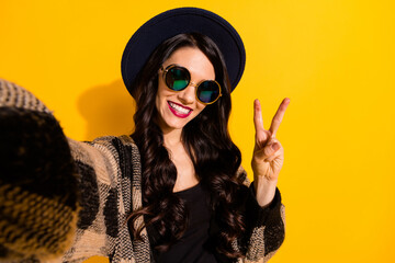 Sticker - Photo of pretty happy young woman wear cool glasses make v-sign selfie face isolated on yellow color background