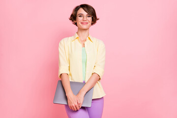 Poster - Photo of charming shiny young woman wear yellow shirt glasses holding modern device isolated pink color background