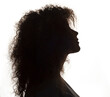 Silhouette of beautiful girl with curly hair isolated on white background.